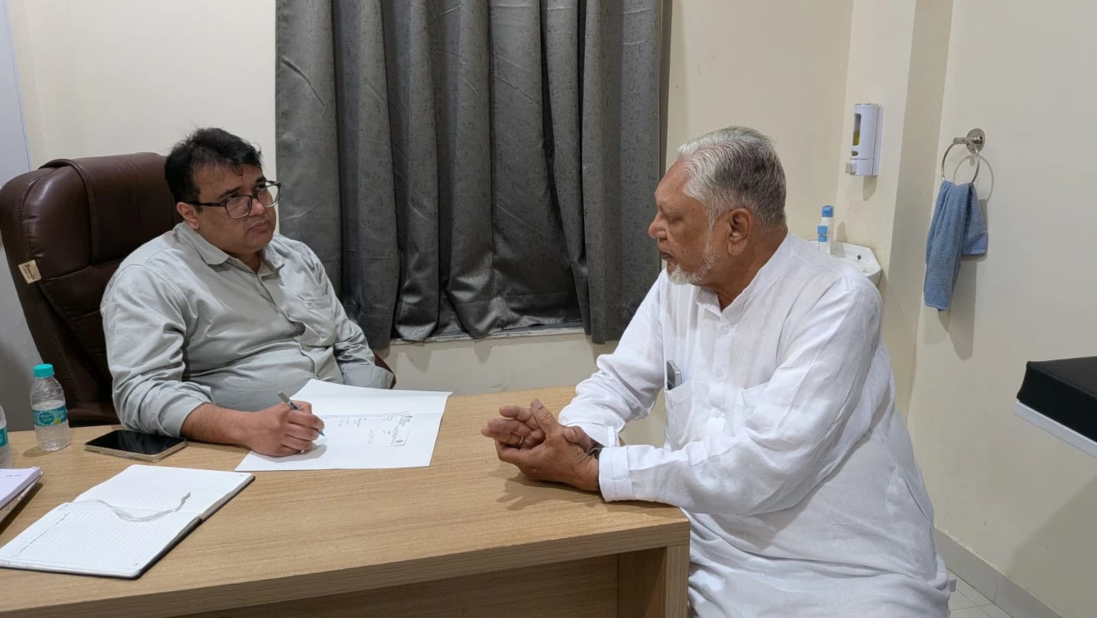 Dr. Abhilekh consulting with a patient
